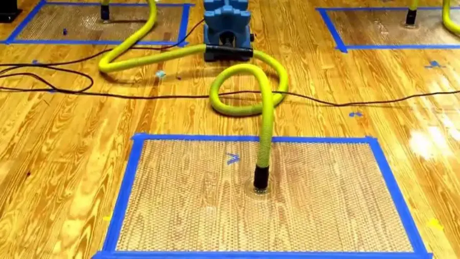 Hardwood floor drying mats taped over a wet floor in a Redmond home