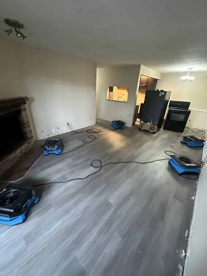 Air movers drying the vinyl plank floor of a Redmond condo living room